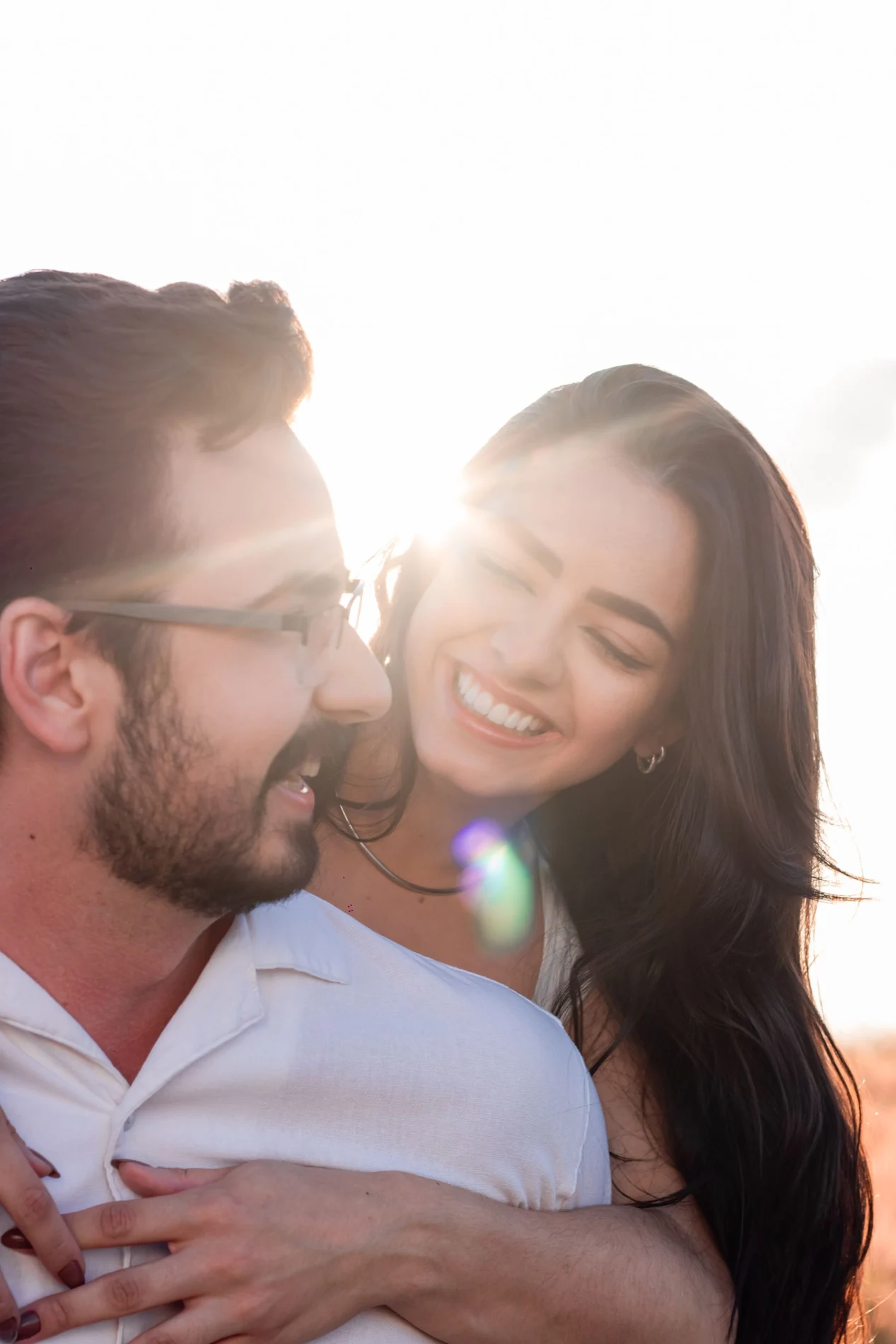 Two people sharing a smile in warm evening sunlight