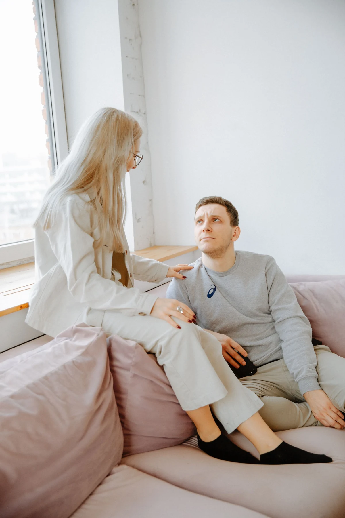 A couple talking together on a sofa