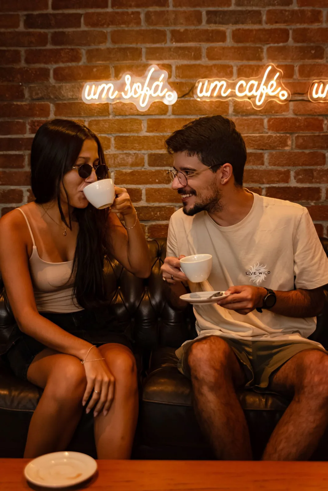 A couple shares a joyful coffee moment together, capturing love and relaxation.