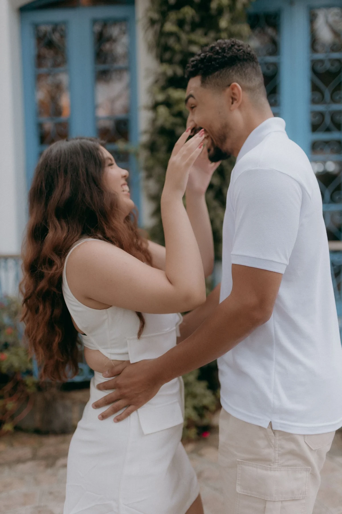 Happy couple sharing a joyful moment outdoors during summer.