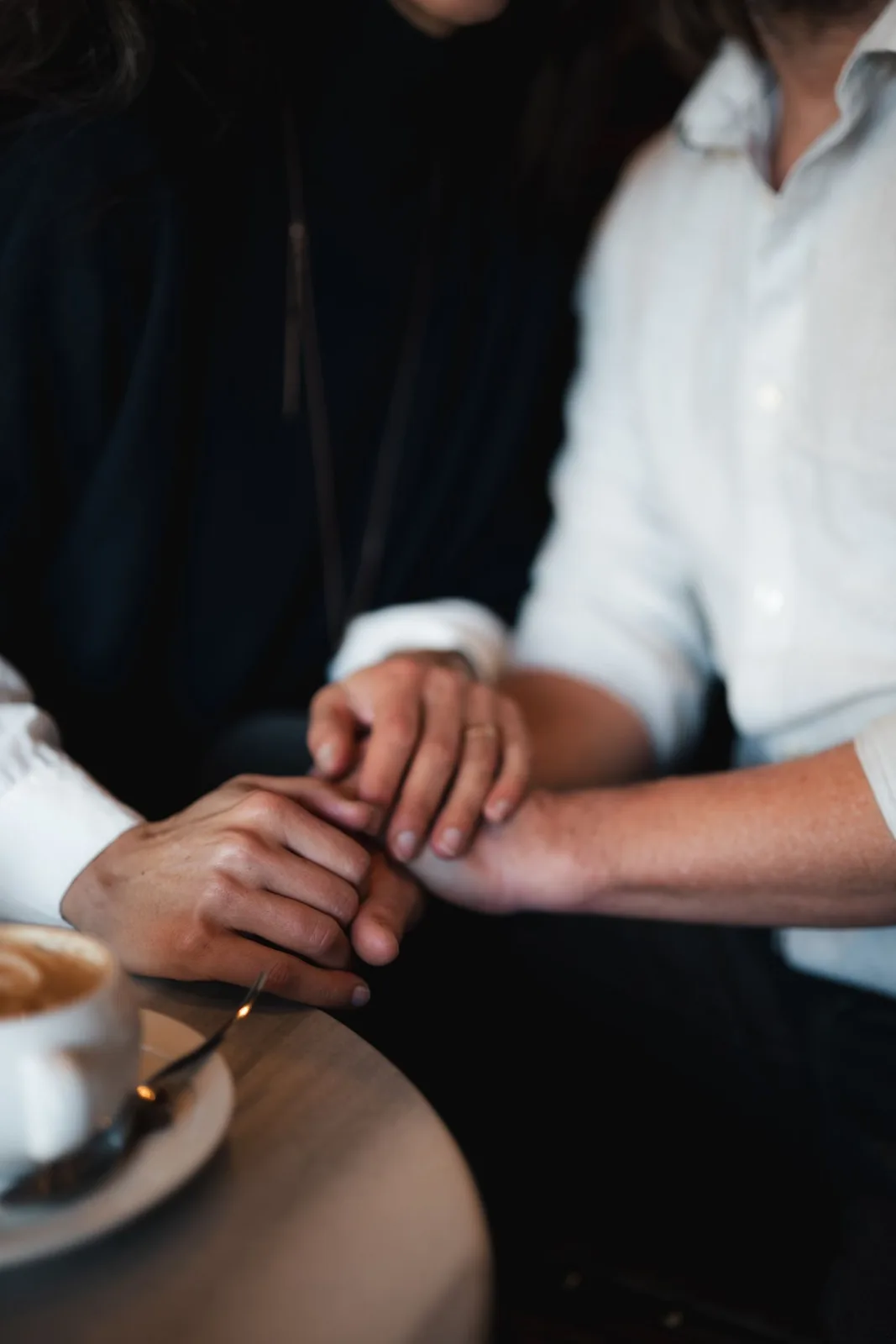A heartfelt moment as a couple enjoys coffee, expressing love and connection.