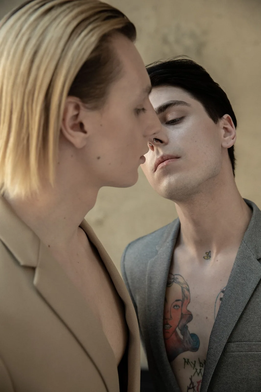 An artistic portrait capturing the intimate connection of a fashionable couple gazing at each other.